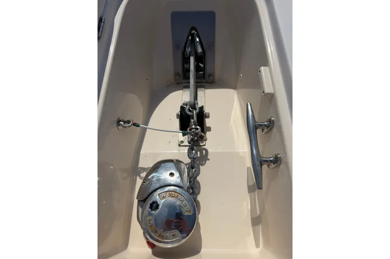 Slide: The Image of Anchor system of a 2008 Grady-White Canyon 336 boat, featuring a windlass and cleat. - 35