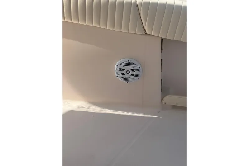 Slide: The Image of 2008 Grady-White Canyon 336 boat interior with speaker and cushioned seating. - 37