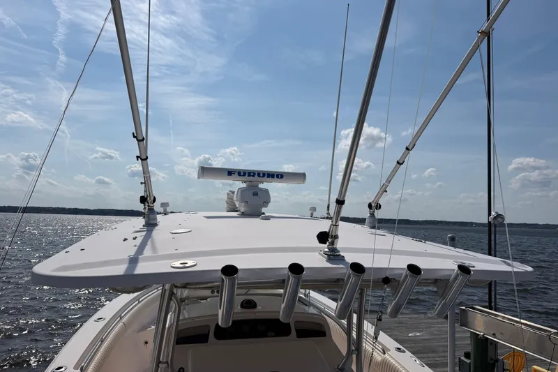 Slide: The Image of 2008 Grady-White Canyon 336 boat with fishing rod holders and radar on a sunny day. - 43