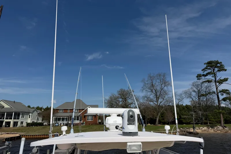 Slide: The Image of 2008 Grady-White Canyon 336 boat docked near waterfront homes under clear blue sky. - 44