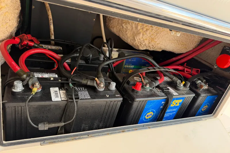 Slide: The Image of Battery compartment of a 2008 Grady-White Canyon 336 boat with multiple connected batteries. - 46