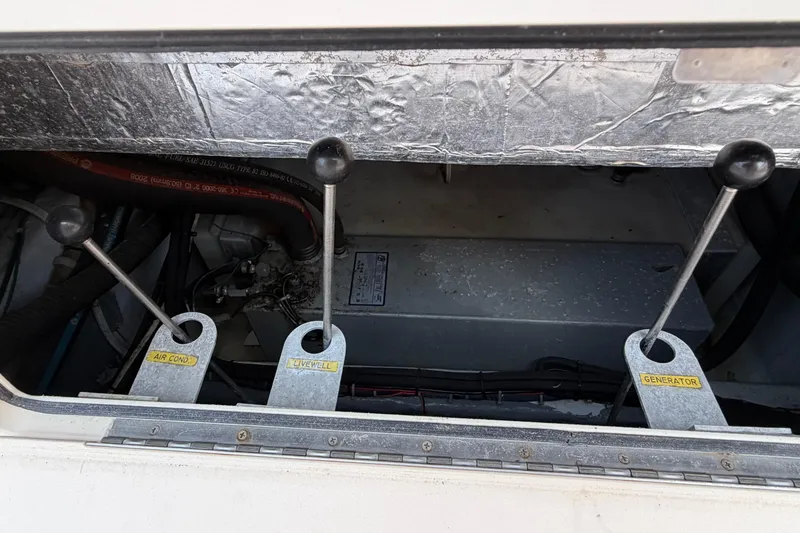 Slide: The Image of Control levers on a 2008 Grady-White Canyon 336 boat, labeled for air conditioning, livewell, and generator. - 6