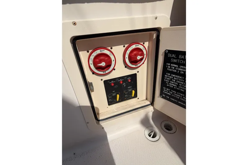 Slide: The Image of 2008 Grady-White Canyon 336 dual battery switch panel with red dials and instructions. - 9