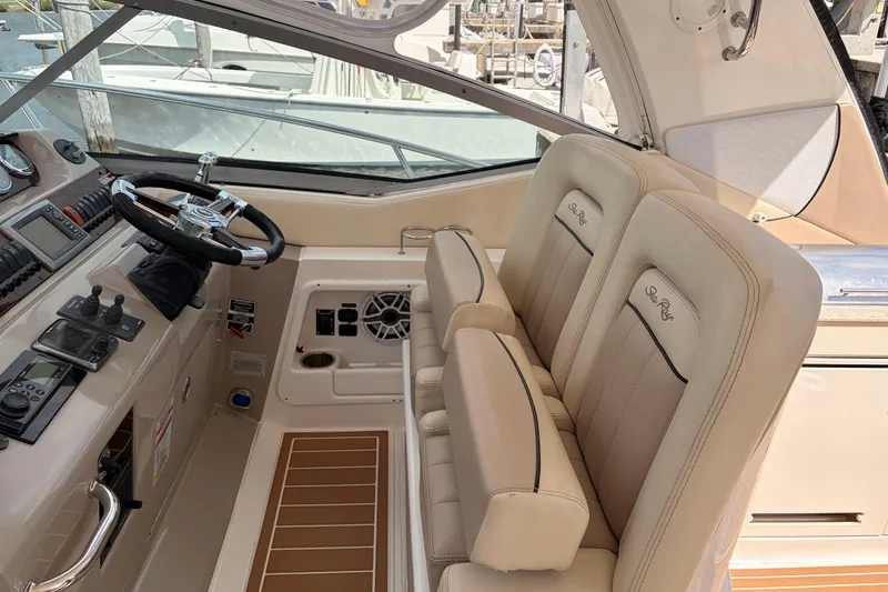 Slide: The Image of 2008 Sea Ray Sundancer 350 helm with beige seating and modern controls. - 16