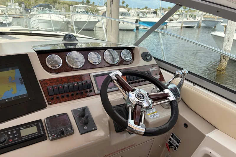 Slide: The Image of Cockpit of 2008 Sea Ray Sundancer 350 with steering wheel and navigation instruments. - 18