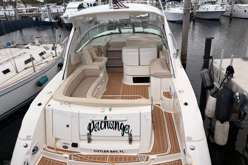 Slide: The Image of 2008 Sea Ray Sundancer 350 docked, featuring spacious seating and elegant design. - 2