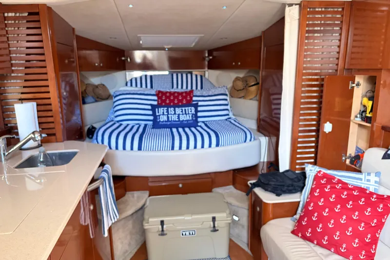 Slide: The Image of 2008 Sea Ray Sundancer 350 cabin interior with striped bedding and nautical decor. - 23
