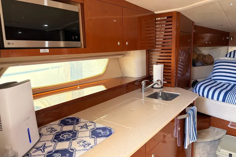 Slide: The Image of Interior of 2008 Sea Ray Sundancer 350 yacht with kitchenette and cozy sleeping area. - 27