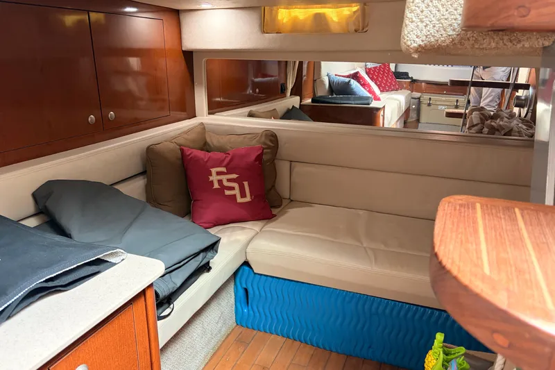 Slide: The Image of Interior of 2008 Sea Ray Sundancer 350 with beige seating and decorative pillows. - 28