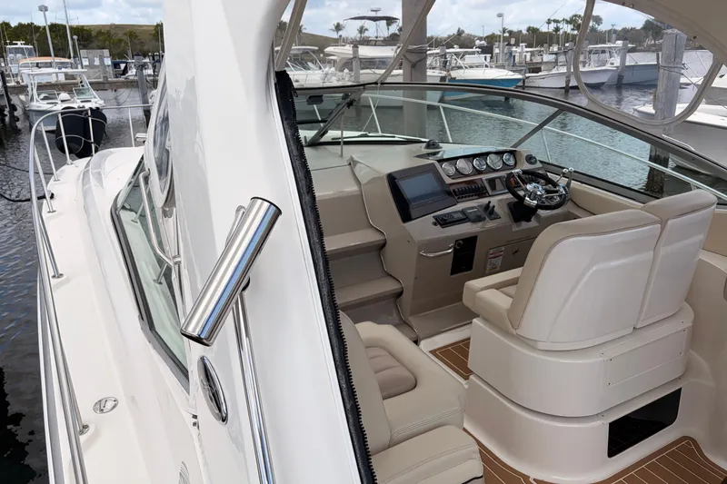 Slide: The Image of 2008 Sea Ray Sundancer 350 yacht cockpit with modern controls and comfortable seating at marina. - 3