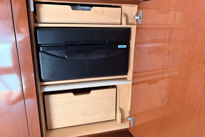 Slide: The Image of Wooden cabinet with drawers inside a 2008 Sea Ray Sundancer 350 boat. - 31