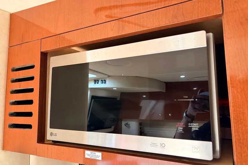 Slide: The Image of LG microwave in 2008 Sea Ray Sundancer 350 yacht kitchen, wooden cabinetry. - 34