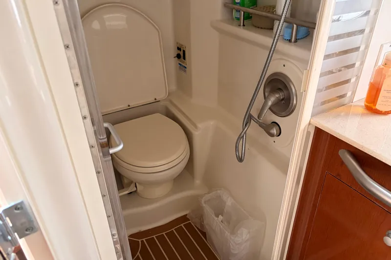 Slide: The Image of 2008 Sea Ray Sundancer 350 bathroom with toilet, shower, and wooden flooring. - 37
