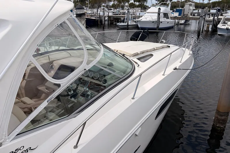 Slide: The Image of 2008 Sea Ray Sundancer 350 yacht docked at marina, showcasing sleek design and cockpit. - 40