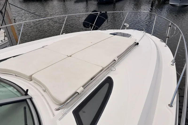 Slide: The Image of 2008 Sea Ray Sundancer 350 yacht with sun pads on deck, docked in marina. - 42