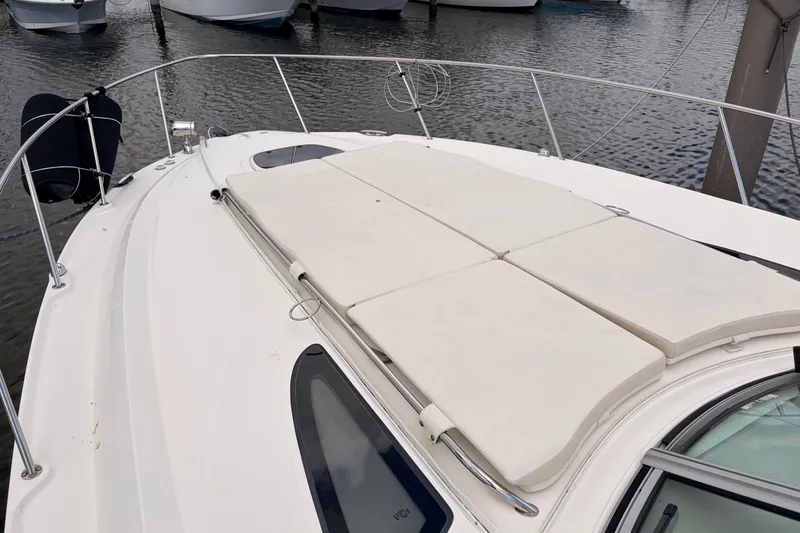 Slide: The Image of 2008 Sea Ray Sundancer 350 yacht with sun pads on deck, docked at marina. - 44
