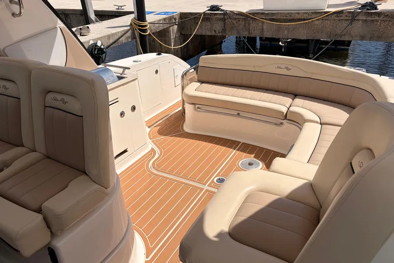 Slide: The Image of Luxurious 2008 Sea Ray Sundancer 350 boat interior with beige seating and teak flooring. - 7