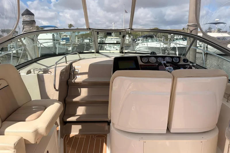 Slide: The Image of 2008 Sea Ray Sundancer 350 cockpit with helm, seating, and marina view. - 8