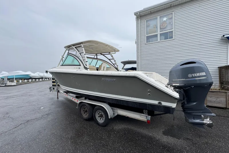 The Image of 2016 Pursuit DC 265 Dual Console boat on trailer with Yamaha outboard motor. - 0