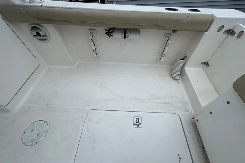 Slide: The Image of 2016 Pursuit DC 265 Dual Console boat interior with storage compartments and seating. - 15