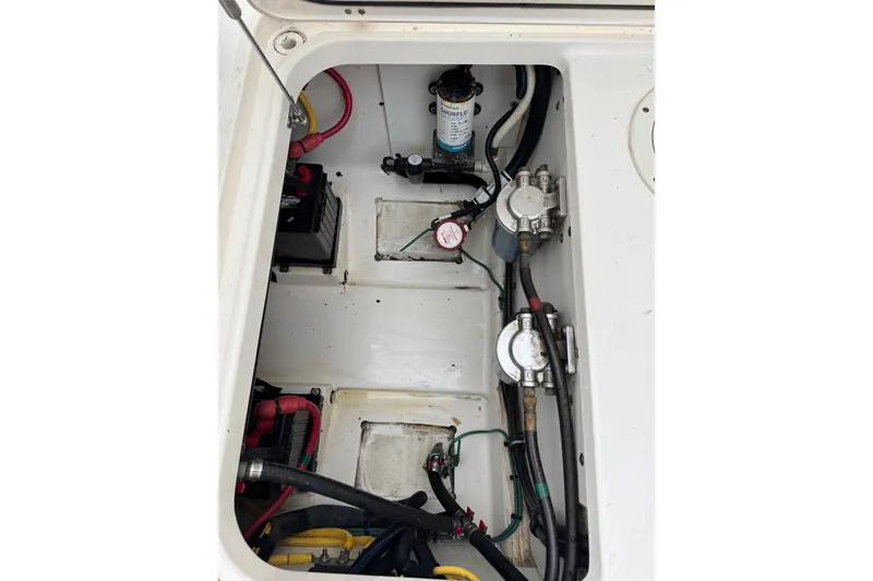 Slide: The Image of 2016 Pursuit DC 265 Dual Console boat engine compartment with wiring and components. - 19