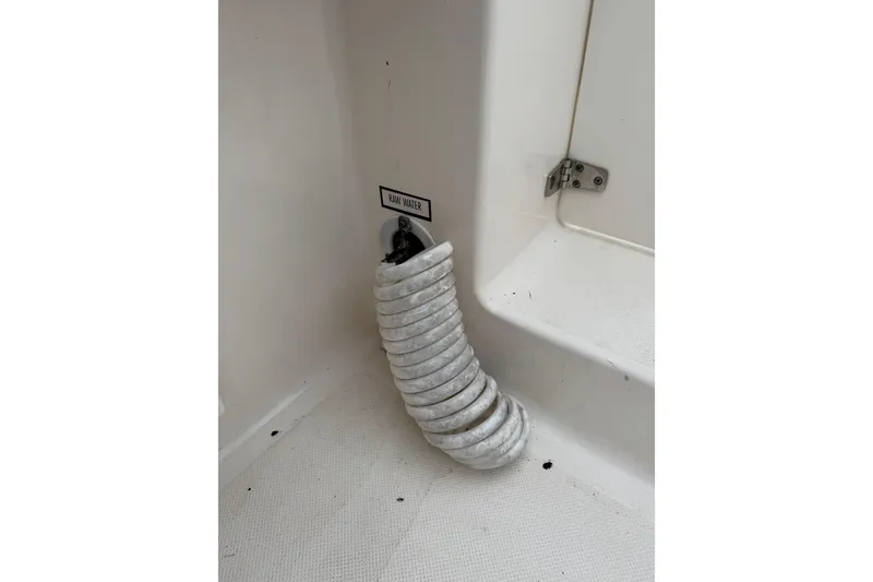 Slide: The Image of Raw water hose in 2016 Pursuit DC 265 Dual Console boat interior. - 20