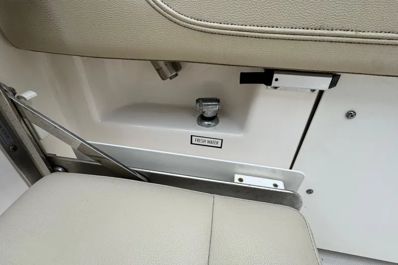 Slide: The Image of Fresh water access on 2016 Pursuit DC 265 Dual Console boat interior. - 21