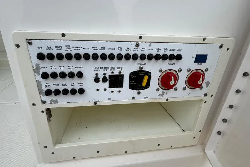 Slide: The Image of Control panel of a 2016 Pursuit DC 265 Dual Console boat with various switches. - 24