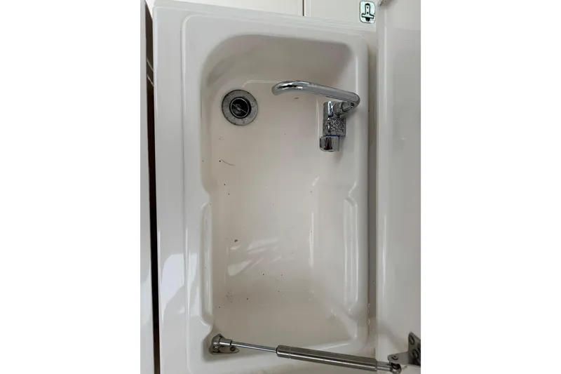 Slide: The Image of 2016 Pursuit DC 265 Dual Console sink with chrome faucet and drain. - 27