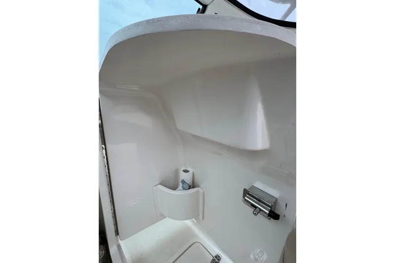 Slide: The Image of Interior view of a 2016 Pursuit DC 265 Dual Console boat, featuring a clean, white finish. - 34