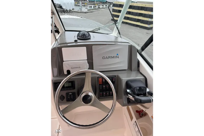 Slide: The Image of Steering console of 2016 Pursuit DC 265 Dual Console boat with Garmin navigation system. - 37