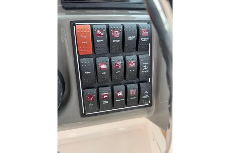 Slide: The Image of Control panel of a 2016 Pursuit DC 265 Dual Console boat with labeled switches. - 40