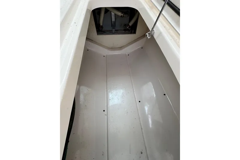 Slide: The Image of Interior view of a 2016 Pursuit DC 265 Dual Console boat compartment. - 42