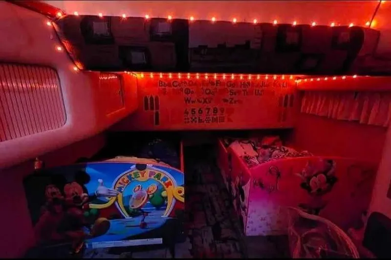 Slide: The Image of Cozy 1997 Sea Ray 400 Sedan Bridge cabin with playful decor and warm lighting. - 12