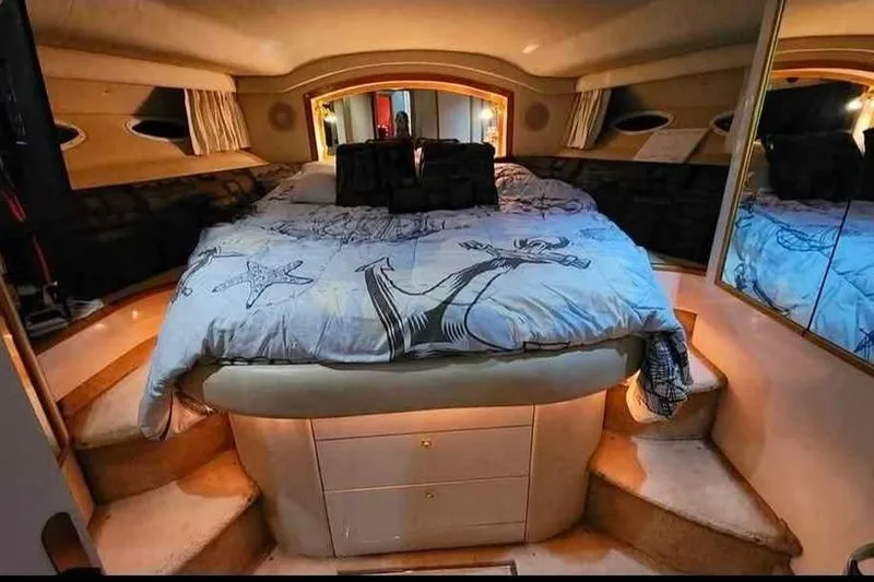 Slide: The Image of Luxurious bedroom interior of 1997 Sea Ray 400 Sedan Bridge yacht with cozy bedding. - 5