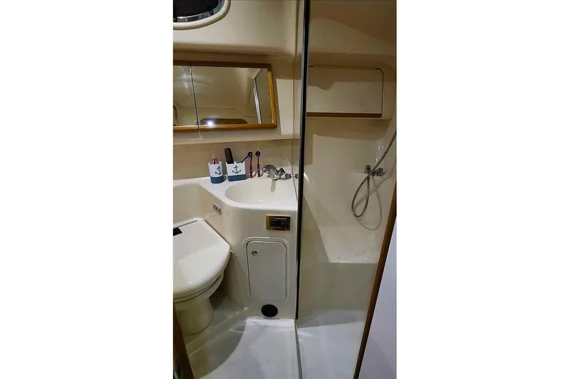 Slide: The Image of Bathroom interior of 1997 Sea Ray 400 Sedan Bridge yacht, featuring sink and shower. - 8