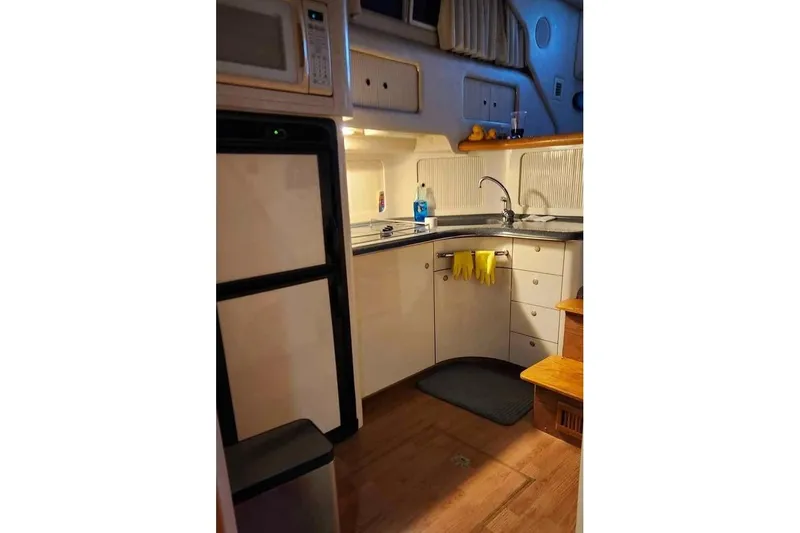 Slide: The Image of Interior of 1997 Sea Ray 400 Sedan Bridge yacht kitchen with appliances and sink. - 9