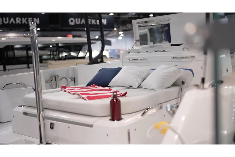 Slide: The Image of 2026 Wellcraft 28 T-Top boat interior with cushioned seating and nautical decor. - 6