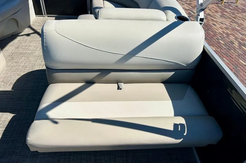 Slide: The Image of 2023 Cypress Cay Seabreeze 232 boat seat with beige upholstery and cup holder. - 16