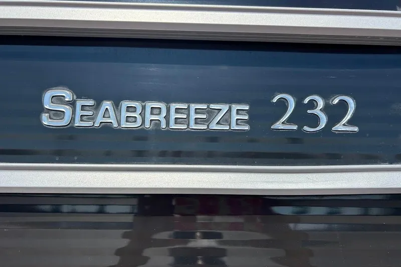 Slide: The Image of 2023 Cypress Cay Seabreeze 232 logo on a sleek black surface. - 25