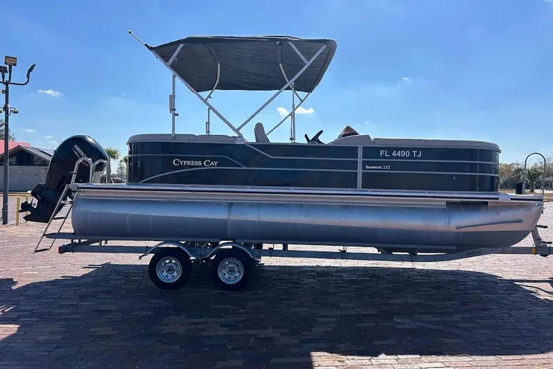 Slide: The Image of 2023 Cypress Cay Seabreeze 232 pontoon boat on trailer under clear sky. - 5