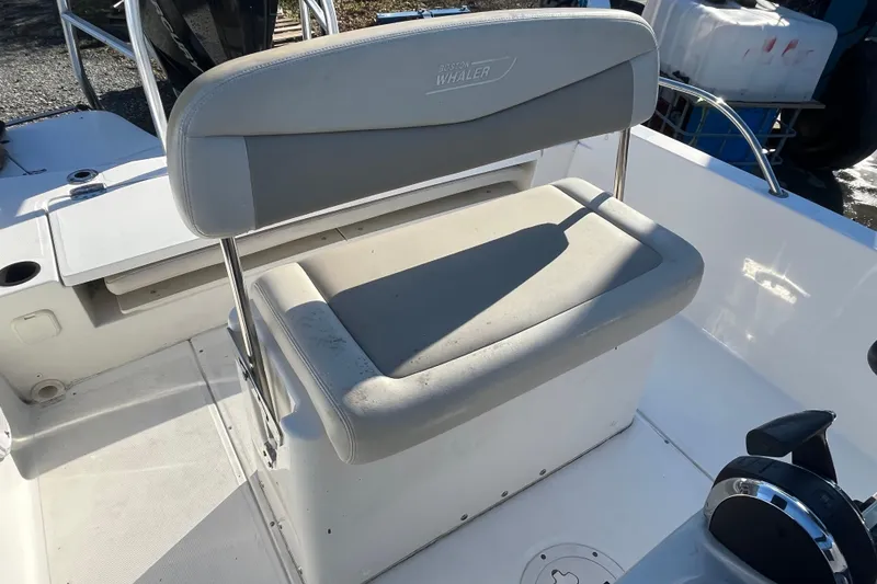 Slide: The Image of Boston Whaler 240 Dauntless 2019 boat seat, white and gray, in sunlight. - 13