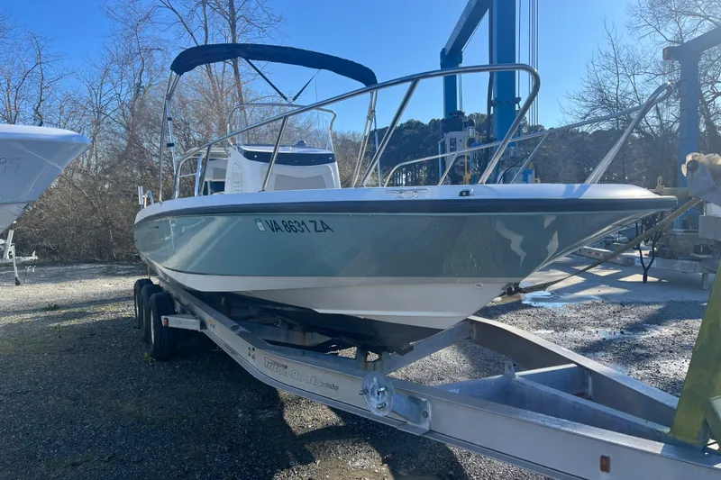 Slide: The Image of 2019 Boston Whaler 240 Dauntless boat on trailer, parked outdoors. - 15
