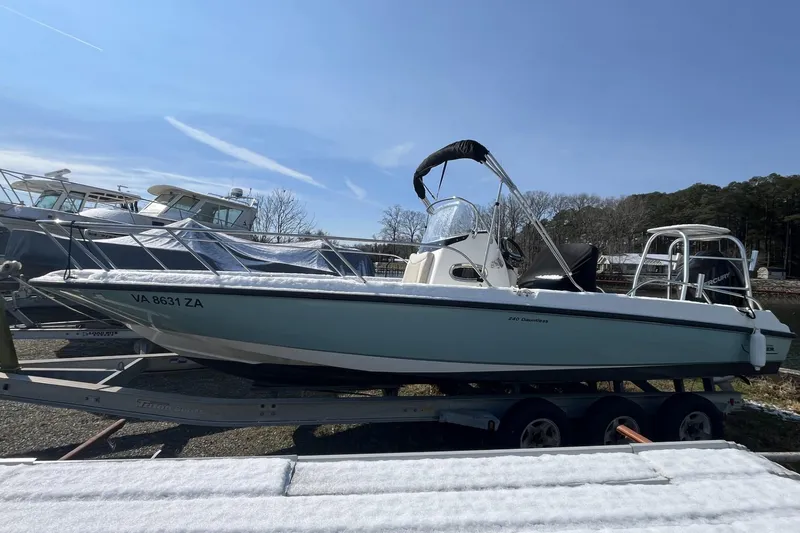 Slide: The Image of 2019 Boston Whaler 240 Dauntless boat on trailer under clear sky. - 5