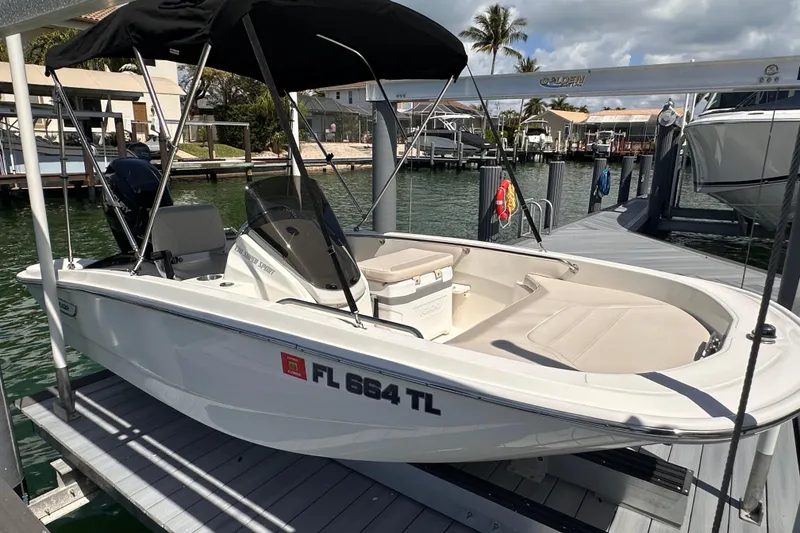 Slide: The Image of 2023 Boston Whaler 13 SS boat docked, featuring sleek design and comfortable seating. - 3