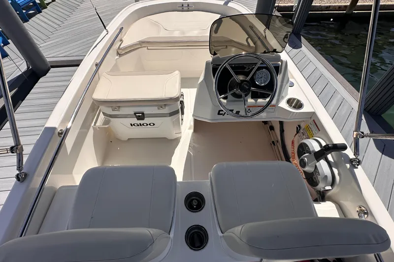 Slide: The Image of 2023 Boston Whaler 13 SS boat interior with steering wheel and Igloo cooler. - 5