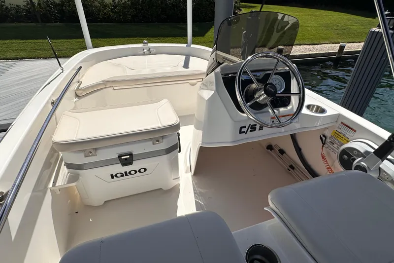 Slide: The Image of 2023 Boston Whaler 13 SS boat interior with Igloo cooler and steering wheel. - 6
