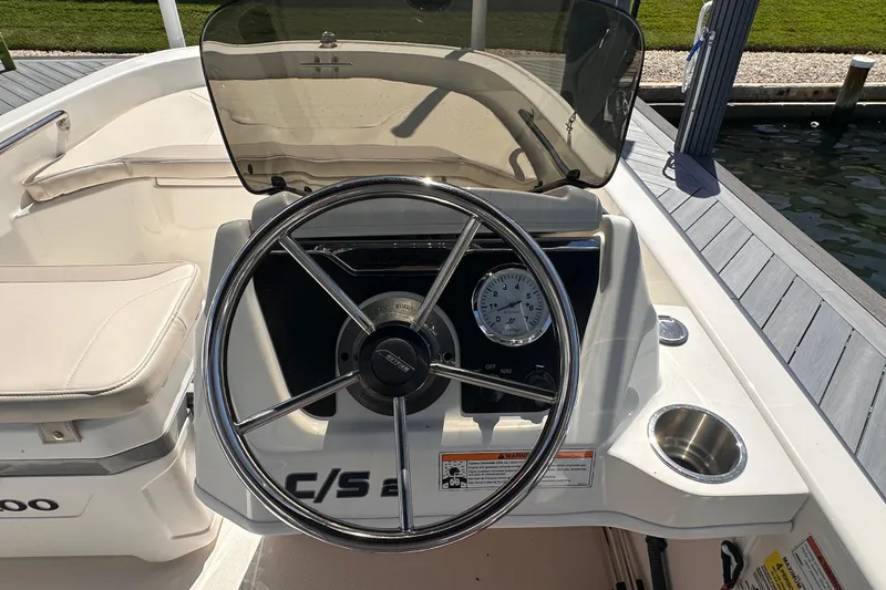 Slide: The Image of 2023 Boston Whaler 13 SS boat dashboard with steering wheel and gauge. - 7