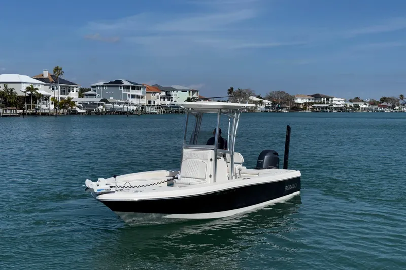 Slide: The Image of 2015 Robalo 226 Cayman boat cruising on a calm coastal waterway. - 18