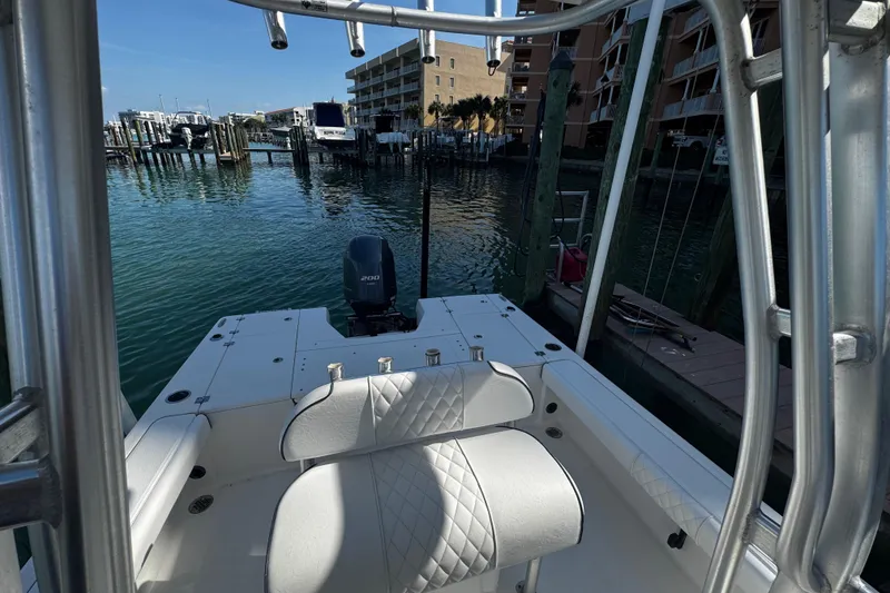Slide: The Image of 2015 Robalo 226 Cayman boat docked at marina with Yamaha 200 engine. - 27